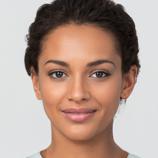 Joyful latino young-adult female with short  brown hair and brown eyes