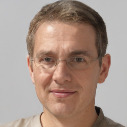 Joyful white middle-aged male with short  brown hair and grey eyes