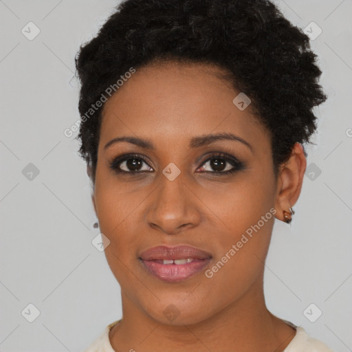 Joyful black young-adult female with short  black hair and brown eyes