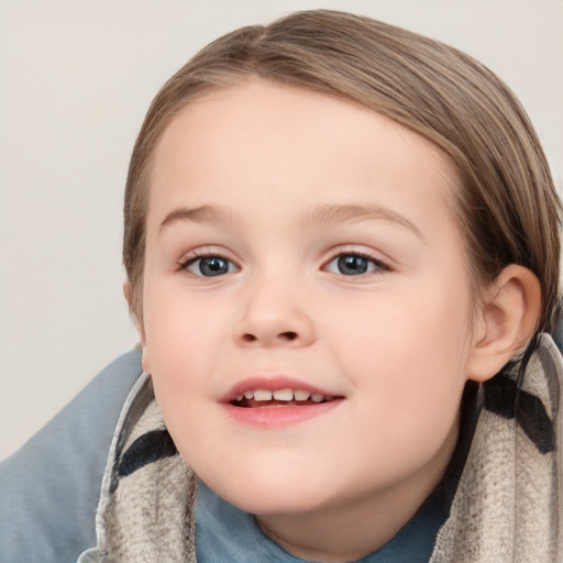 Joyful white child female with short  brown hair and grey eyes