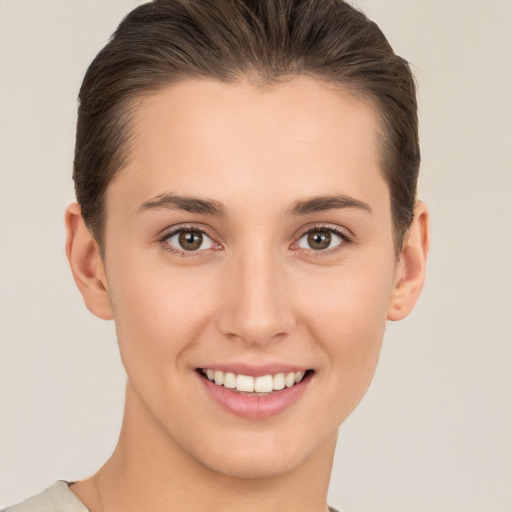 Joyful white young-adult female with short  brown hair and brown eyes