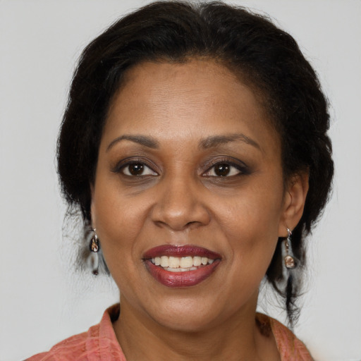 Joyful latino adult female with medium  brown hair and brown eyes