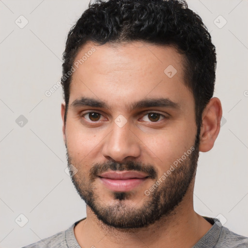 Joyful white young-adult male with short  black hair and brown eyes