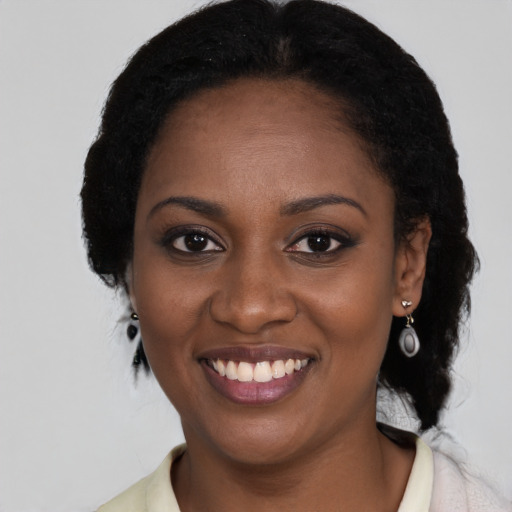 Joyful black young-adult female with medium  black hair and brown eyes