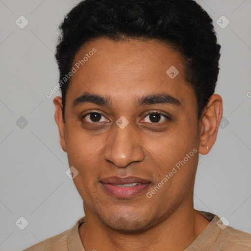 Joyful latino young-adult male with short  black hair and brown eyes