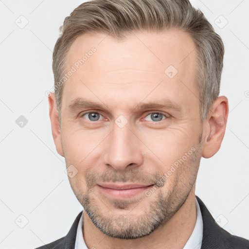 Joyful white adult male with short  brown hair and grey eyes