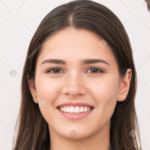 Joyful white young-adult female with long  brown hair and brown eyes