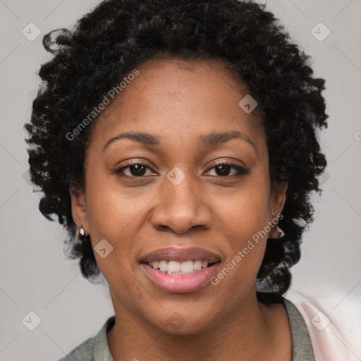 Joyful black adult female with short  brown hair and brown eyes