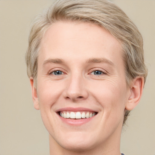 Joyful white young-adult male with medium  brown hair and blue eyes