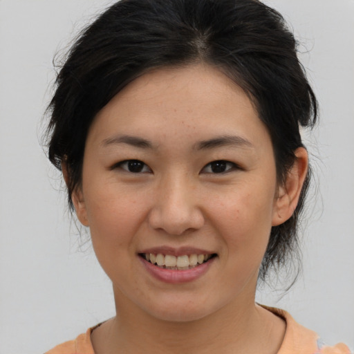 Joyful asian young-adult female with medium  brown hair and brown eyes