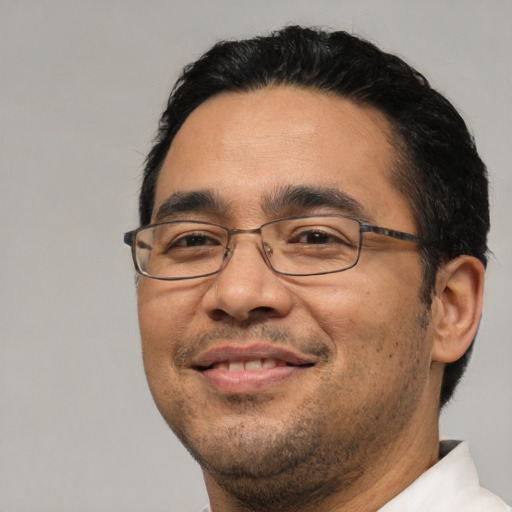 Joyful asian adult male with short  black hair and brown eyes