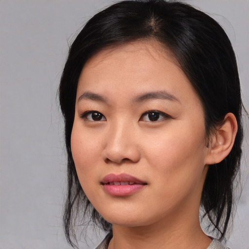 Joyful asian young-adult female with medium  black hair and brown eyes