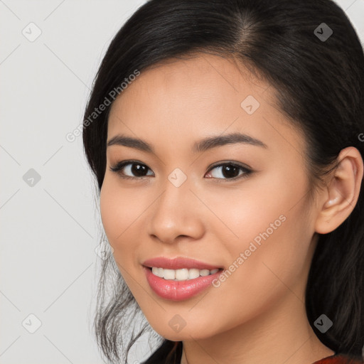 Joyful latino young-adult female with long  black hair and brown eyes