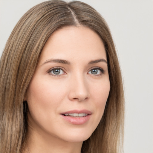 Joyful white young-adult female with long  brown hair and green eyes