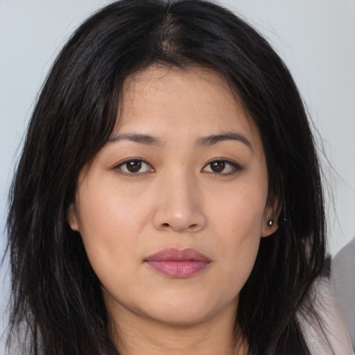 Joyful asian young-adult female with long  brown hair and brown eyes