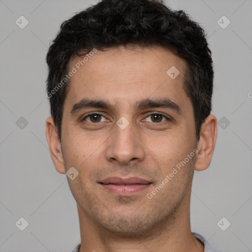 Joyful white young-adult male with short  black hair and brown eyes