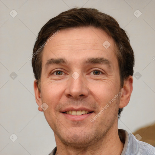 Joyful white adult male with short  brown hair and grey eyes