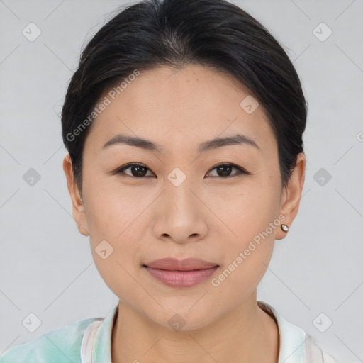 Joyful asian young-adult female with short  brown hair and brown eyes