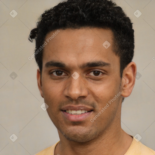 Joyful latino young-adult male with short  black hair and brown eyes