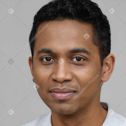 Joyful black young-adult male with short  black hair and brown eyes