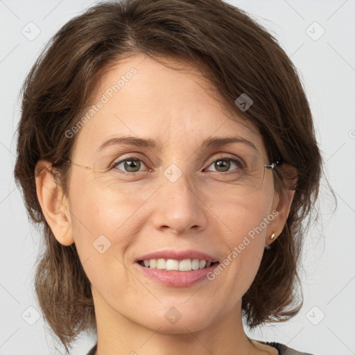 Joyful white adult female with medium  brown hair and grey eyes