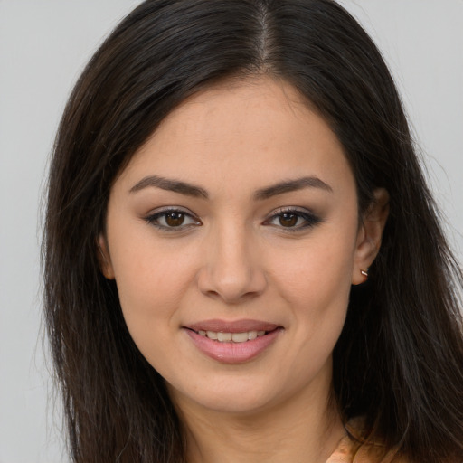 Joyful white young-adult female with long  brown hair and brown eyes
