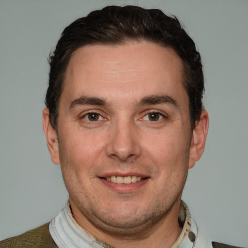 Joyful white adult male with short  brown hair and grey eyes