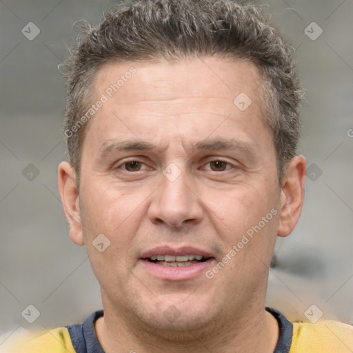 Joyful white adult male with short  brown hair and brown eyes