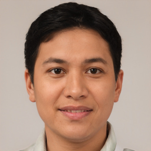 Joyful asian young-adult male with short  brown hair and brown eyes