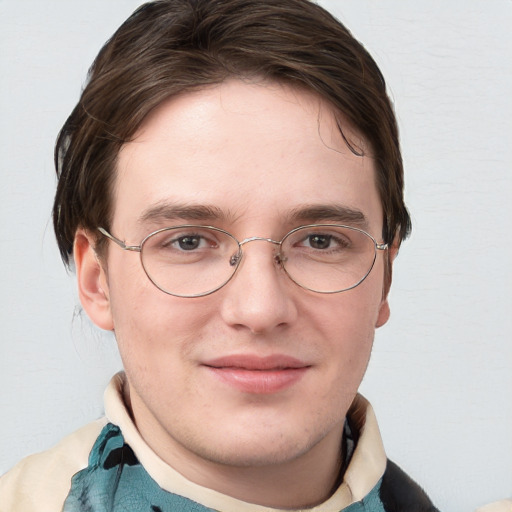 Joyful white young-adult male with short  brown hair and blue eyes