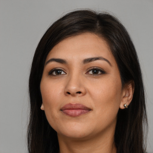 Joyful latino young-adult female with long  brown hair and brown eyes