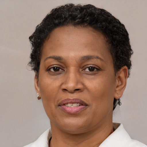 Joyful latino adult female with short  brown hair and brown eyes