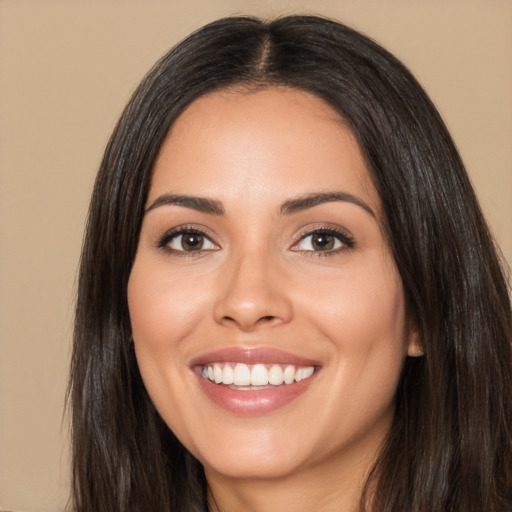 Joyful latino young-adult female with long  brown hair and brown eyes