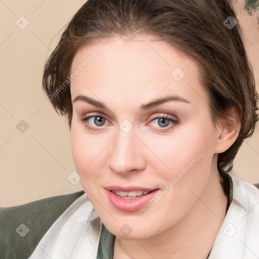 Joyful white young-adult female with medium  brown hair and blue eyes