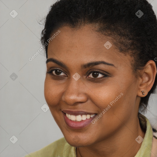 Joyful black young-adult female with short  brown hair and brown eyes