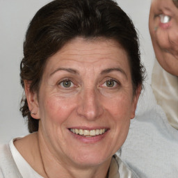 Joyful white adult female with medium  brown hair and blue eyes