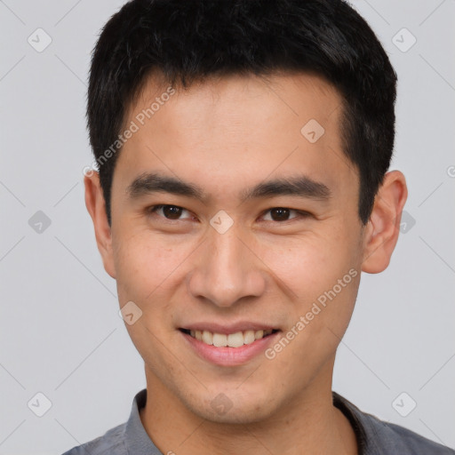 Joyful asian young-adult male with short  brown hair and brown eyes