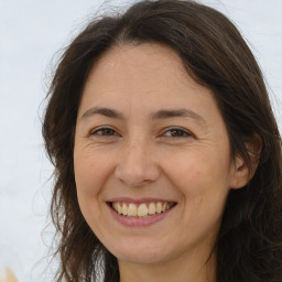 Joyful white adult female with long  brown hair and brown eyes