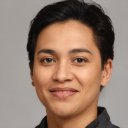 Joyful latino young-adult male with medium  brown hair and brown eyes