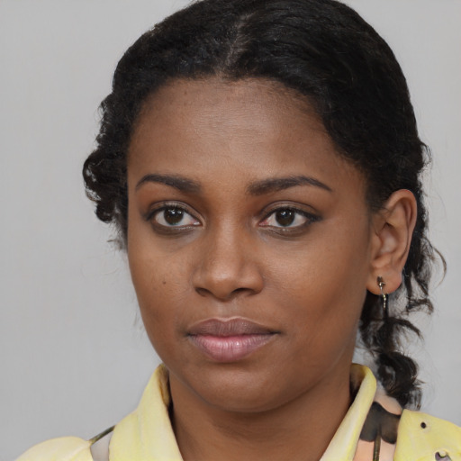 Joyful black young-adult female with medium  brown hair and brown eyes