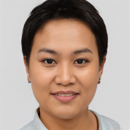 Joyful asian young-adult female with short  brown hair and brown eyes