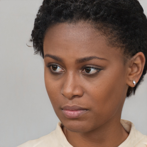 Neutral black young-adult female with short  brown hair and brown eyes