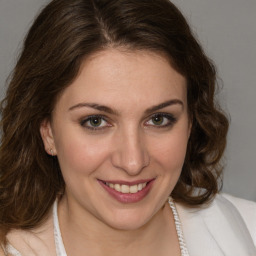 Joyful white young-adult female with medium  brown hair and green eyes