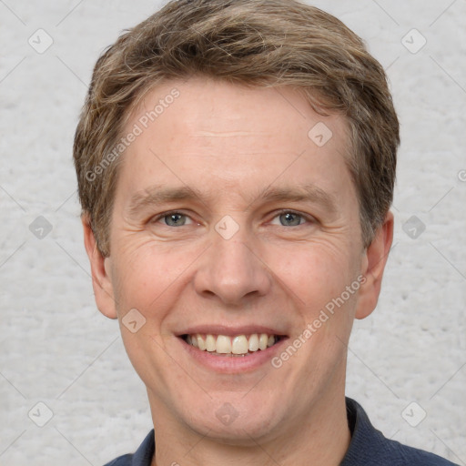 Joyful white adult male with short  brown hair and grey eyes