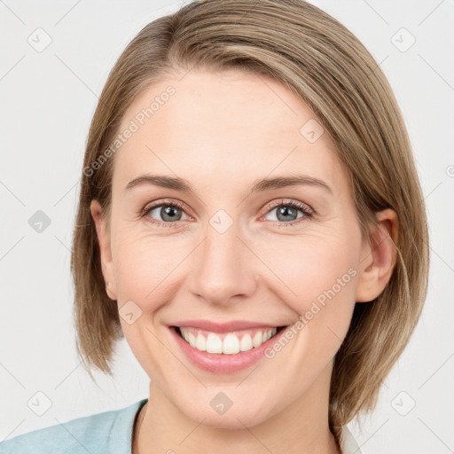 Joyful white young-adult female with medium  brown hair and blue eyes