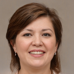 Joyful white young-adult female with medium  brown hair and grey eyes