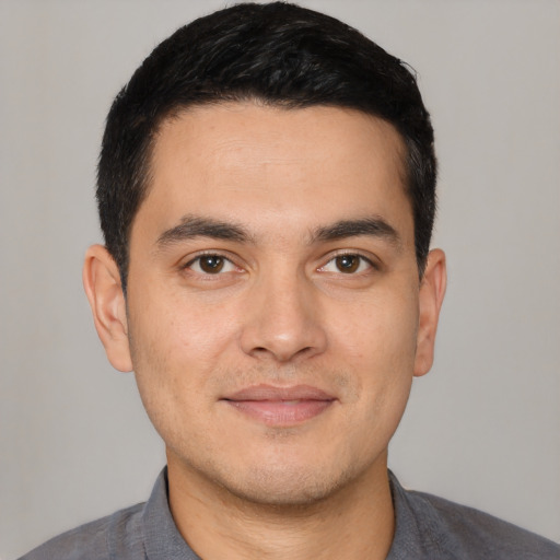 Joyful white young-adult male with short  black hair and brown eyes