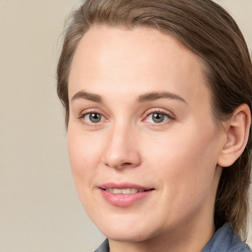 Joyful white young-adult female with medium  brown hair and blue eyes