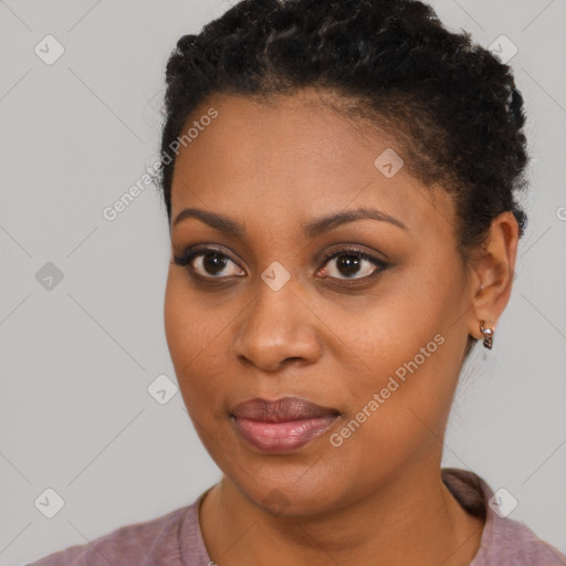 Joyful black young-adult female with short  brown hair and brown eyes