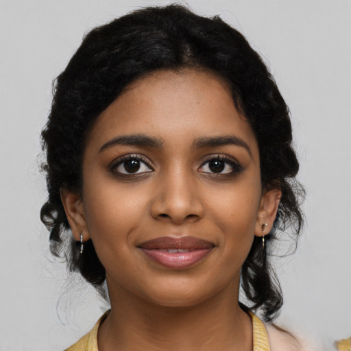 Joyful black young-adult female with medium  black hair and brown eyes